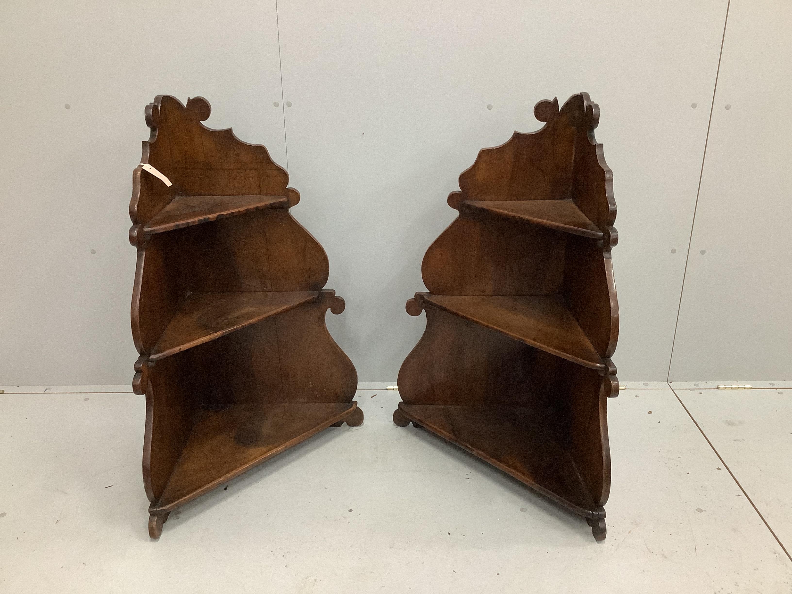 A pair of 18th century style Italian walnut corner three tier wall brackets, width 70cm, depth 32cm, height 97cm